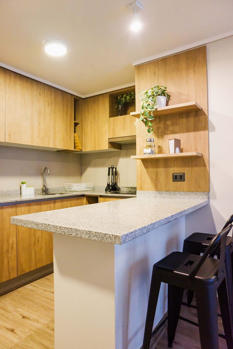 Sleek and modern kitchen with granite countertops and cozy seating, perfect for enjoying a meal or a morning coffee.