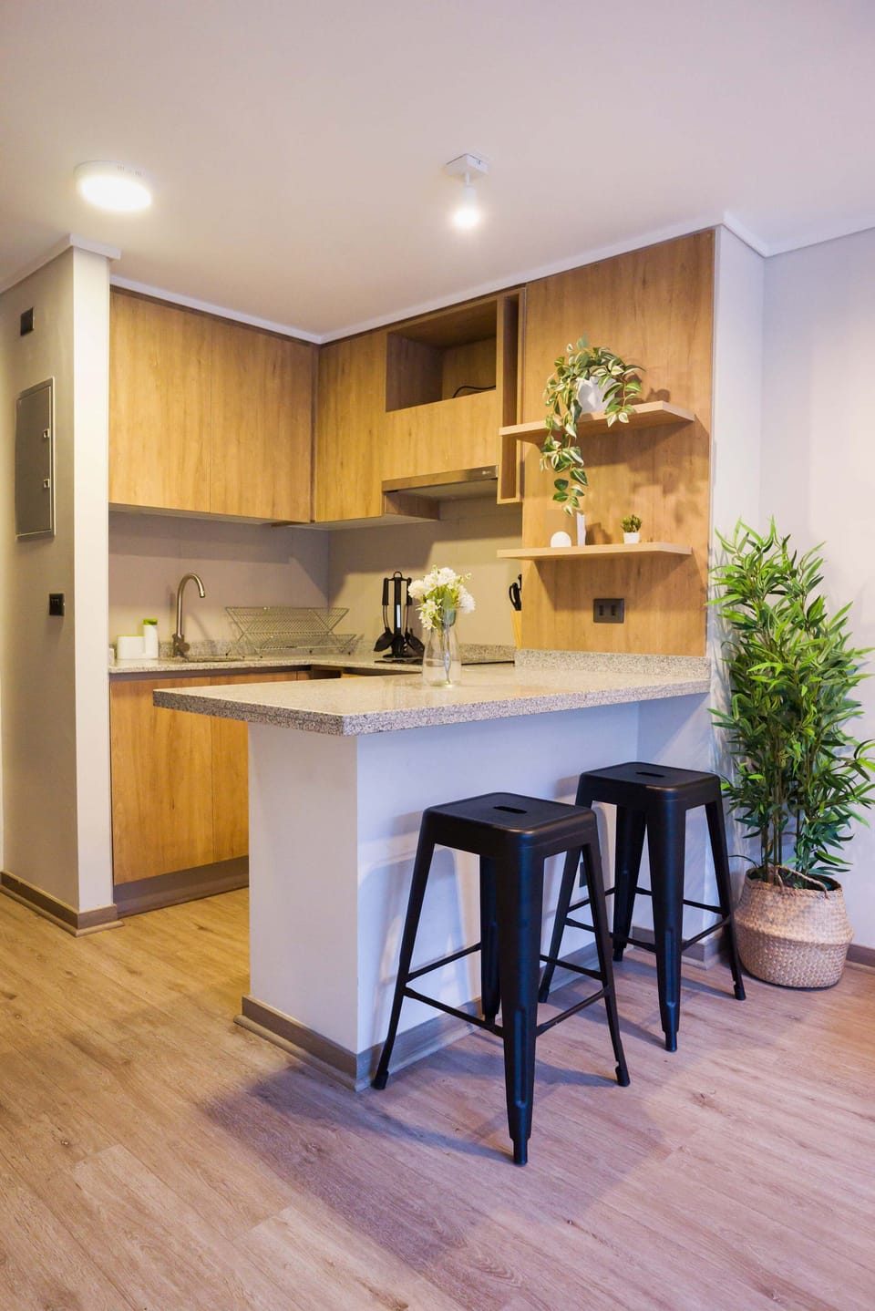 Cozy kitchen with modern amenities and stylish bar seating, perfect for enjoying a meal or a quick coffee.