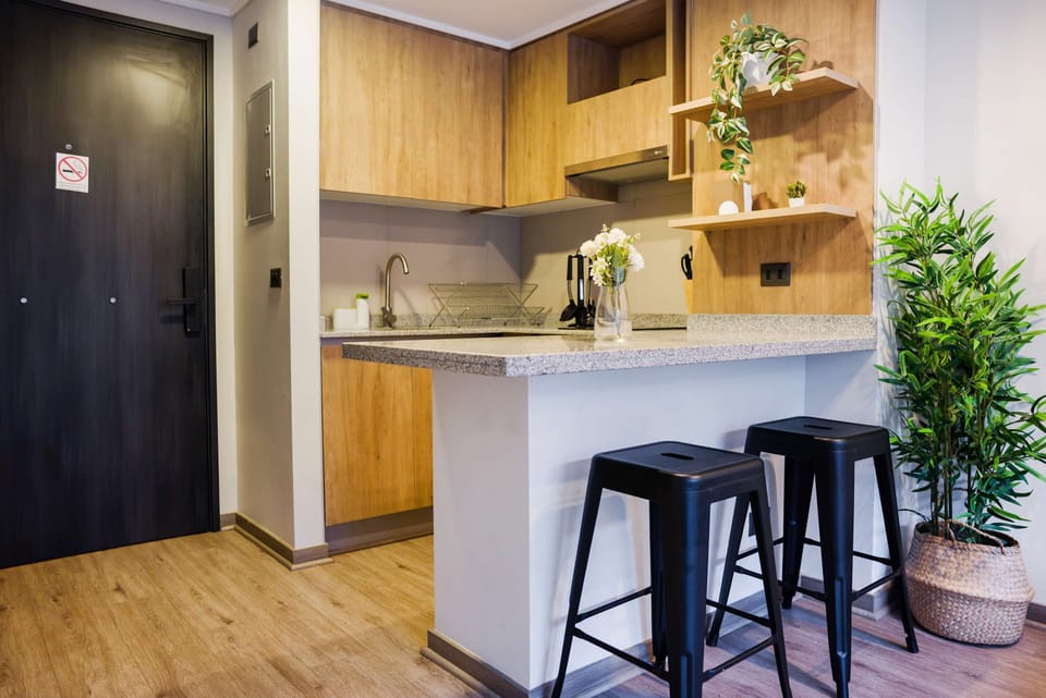 Cozy and modern kitchen with stylish bar seating, perfect for enjoying a quick meal or morning coffee.