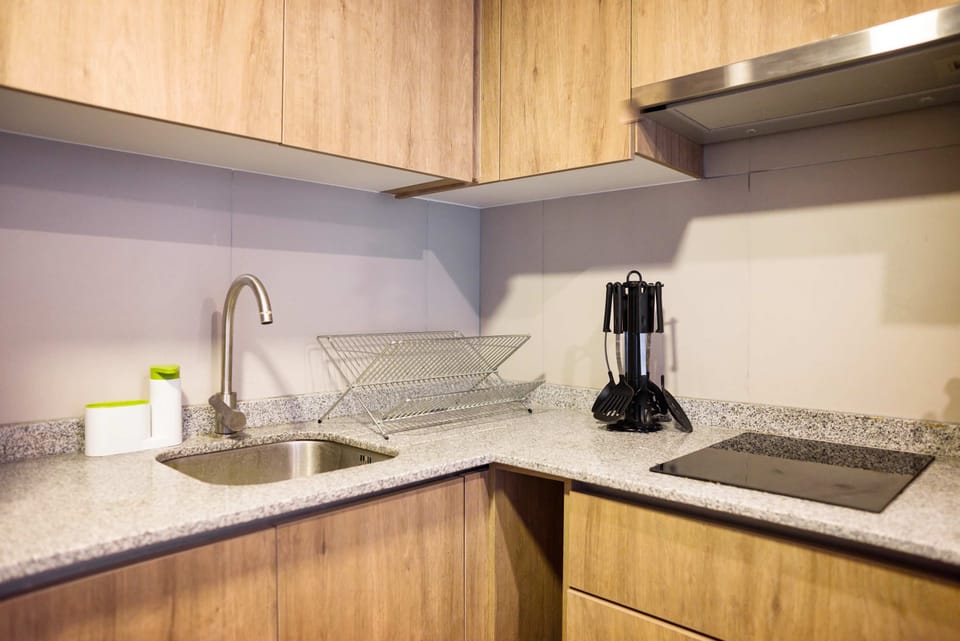 Modern kitchen with sleek granite countertops and all essentials for a cozy stay.