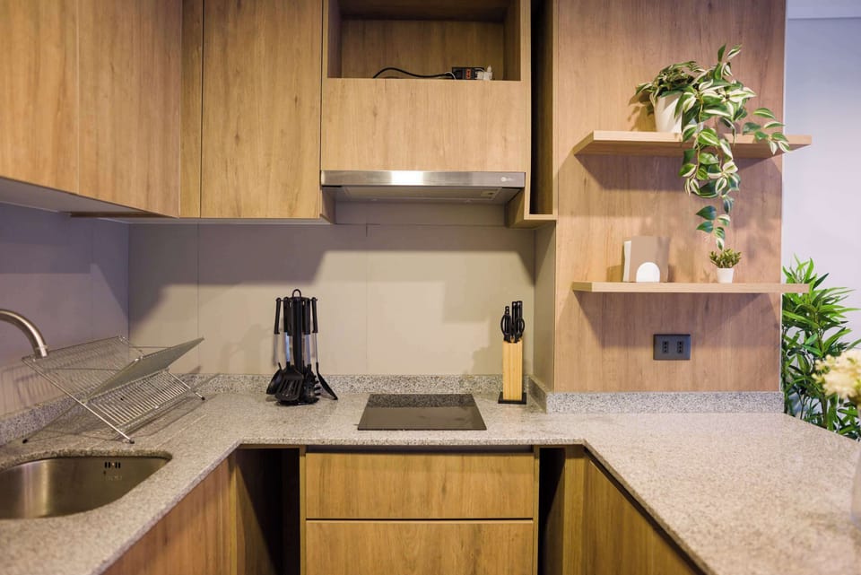 Chic and functional kitchen with modern appliances and stylish wooden cabinetry, perfect for culinary adventures.