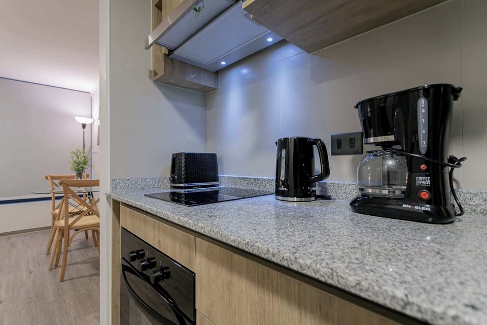 Cozy and modern kitchen with all essentials for a comfortable stay, leading into a charming dining area.