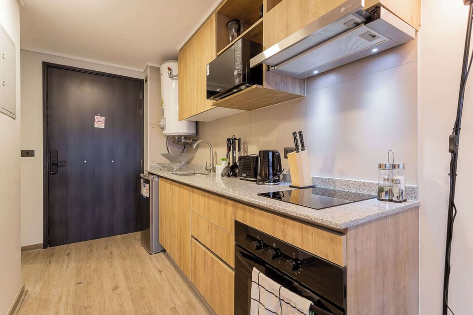 Modern and fully-equipped kitchen perfect for preparing meals in your cozy studio retreat.