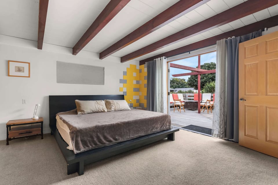 Primary bedroom suite with direct access to the outdoor deck