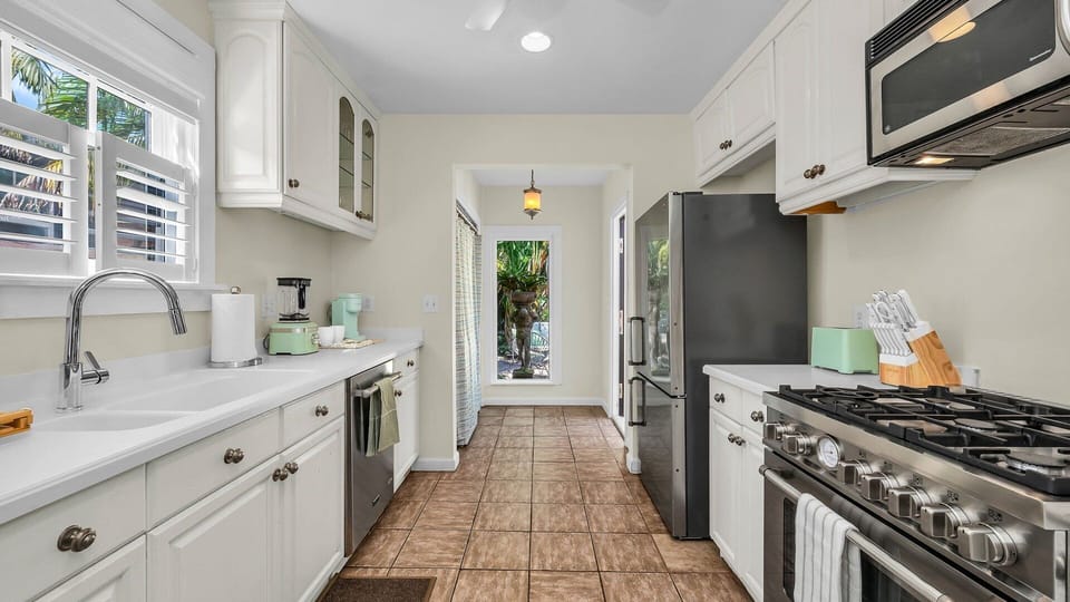 Cook in style! This fully-equipped kitchen features an Italian gas-range stove, Keurig coffee maker with complimentary coffee, toaster, blender, and service-ware for 6—perfect for indoor and outdoor dining.