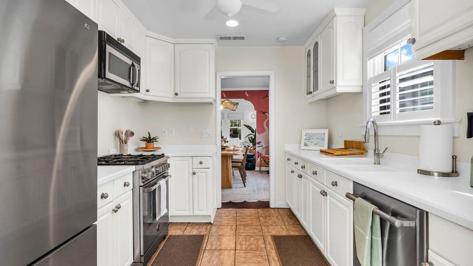 Cook in style! This fully-equipped kitchen features an Italian gas-range stove, Keurig coffee maker with complimentary coffee, toaster, blender, and service-ware for 6—perfect for indoor and outdoor dining.