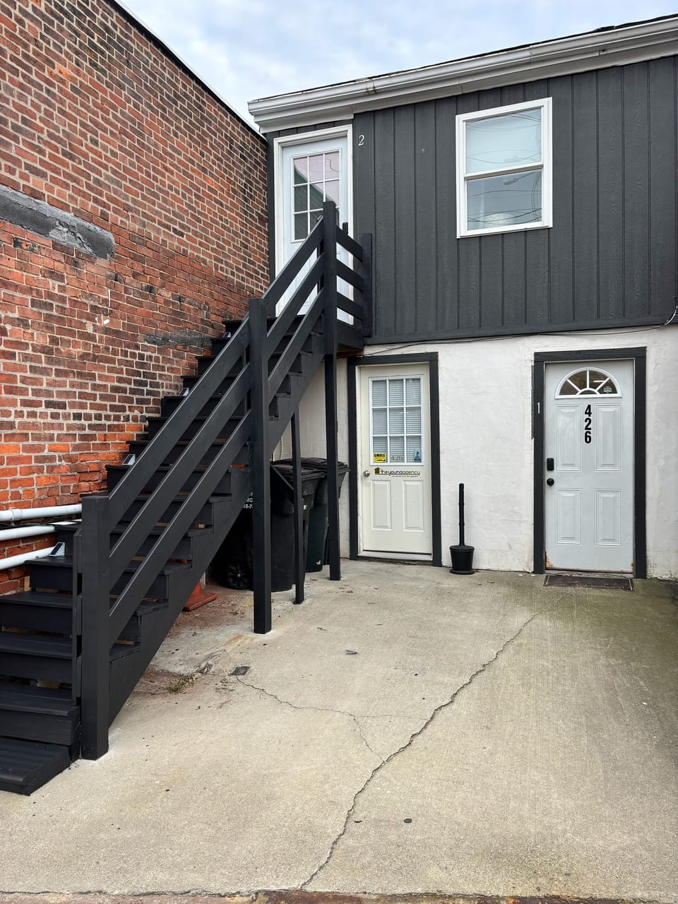 Entry is the door on the right with the vertical 426 on the door and #1 on frame