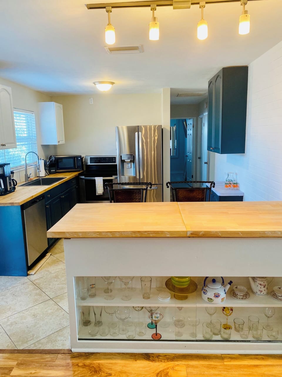 Full kitchen stocked with dishes, silverware, cookware, utensils, and coffee!