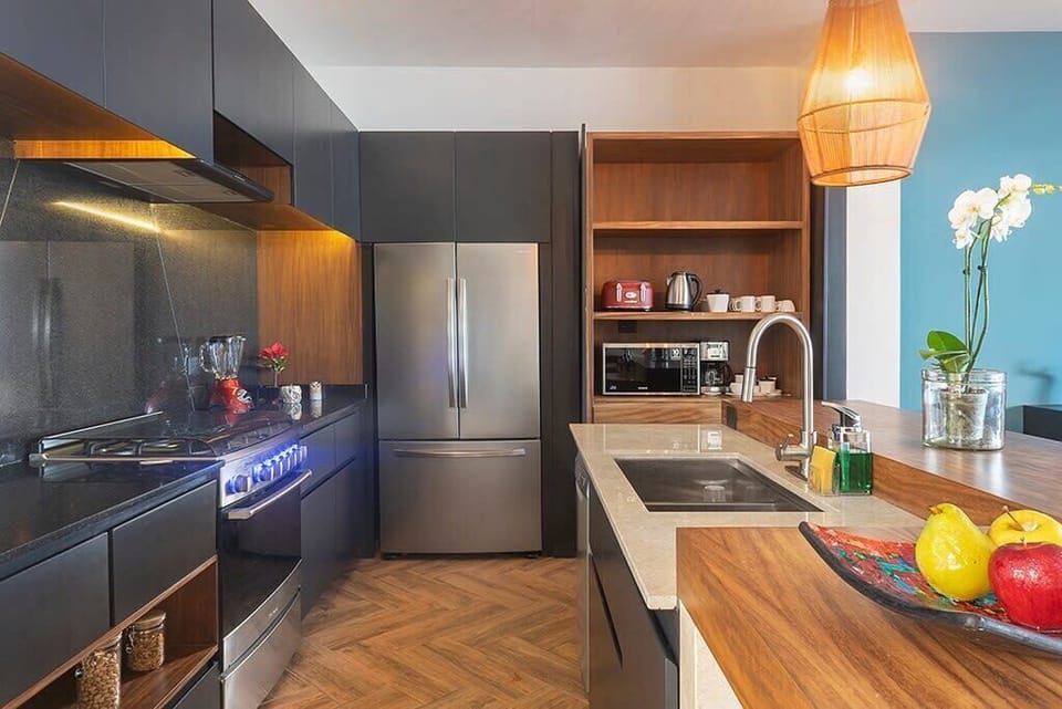 Fully equipped kitchen with modern appliances and dinnerware