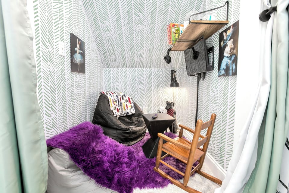 Kids-only nook with games, puzzles, TV, books, bean bags, and fun light toys.