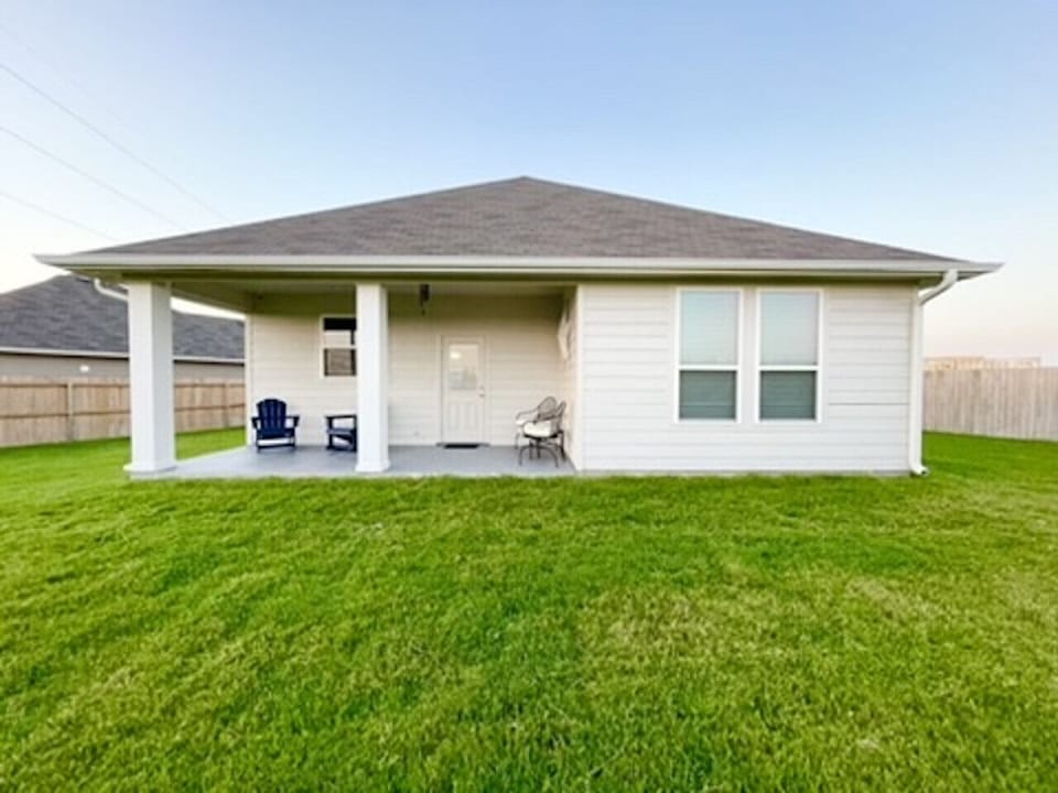 Exterior view of the home with private backyard.