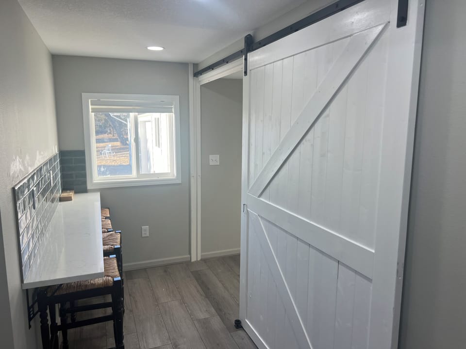 2nd kitchen counter seating with sliding barn door to rec room & full bathroom.