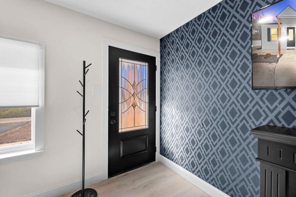 Welcome to the charming front door entry, offering a warm and inviting first impression. With a stylish door and a cozy entryway, this space not only enhances curb appeal but also provides a functional area for guests to arrive and feel at home