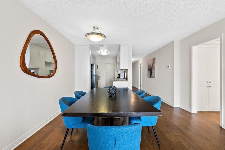 Rich wood flooring and bright natural light create a coastal sanctuary.