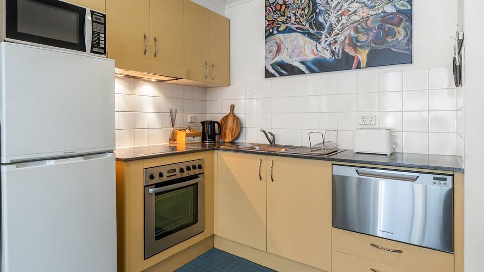 Fully Equipped Kitchen & Dining – Prepare home-cooked meals with all essentials at hand and dine at the sleek glass-top table.