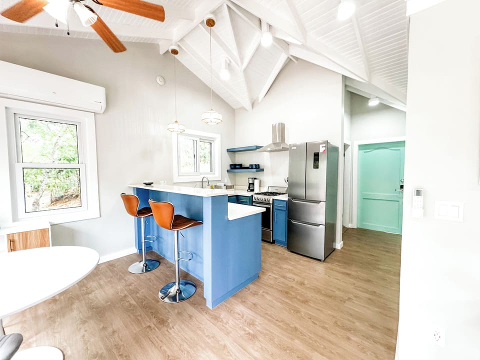Fully stocked kitchen with bar height seating.