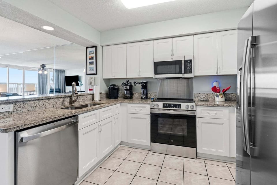 White cabinetry and gray counters in the kitchen at Ashworth 105, an Ocean Drive condo in North Myrtle Beach