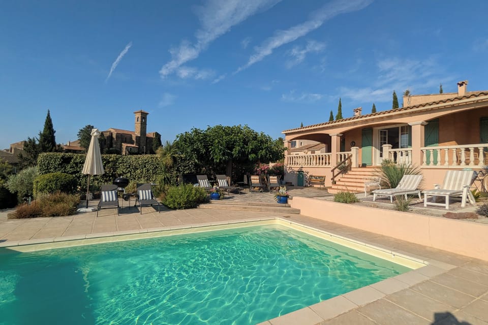 Multiple terraces with shade and loungers around the pool.