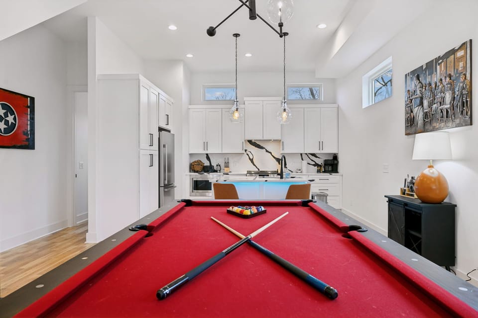 Living Room: This inviting space includes a red pool table, large sectional, and modern design elements for the perfect mix of fun and comfort.