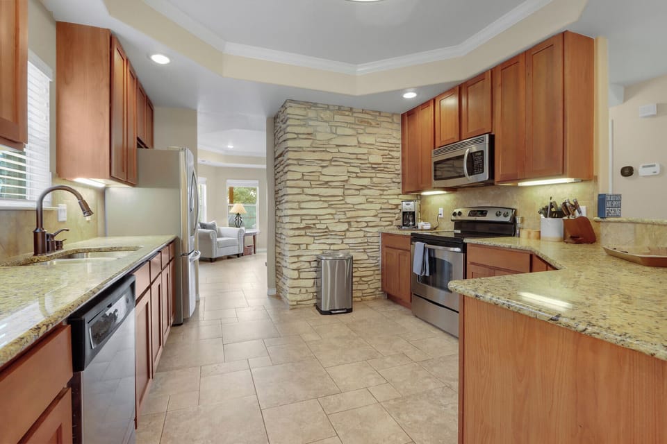 Entering the kitchen.  It's equipped with stainless appliances.