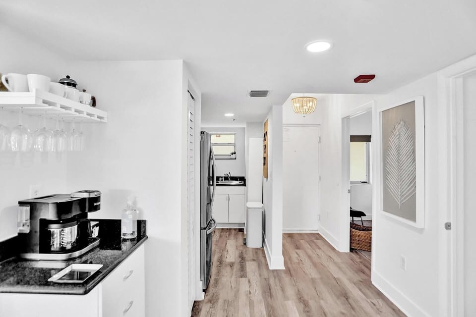 Entryway, guest bedroom, kitchen, and breakfast bar.
