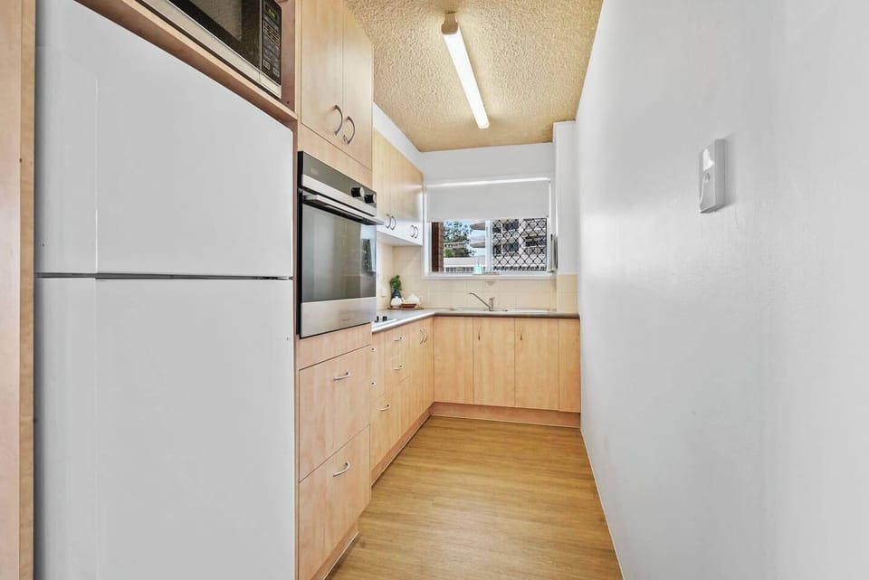 Create delicious meals in the well-equipped kitchen, featuring warm wood cabinetry, an oven and all the essentials for home cooking.