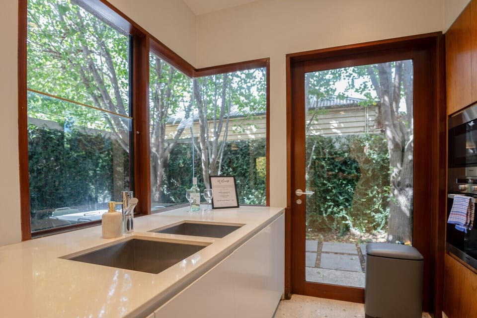 Large glass windows and door overlooking the backyard.