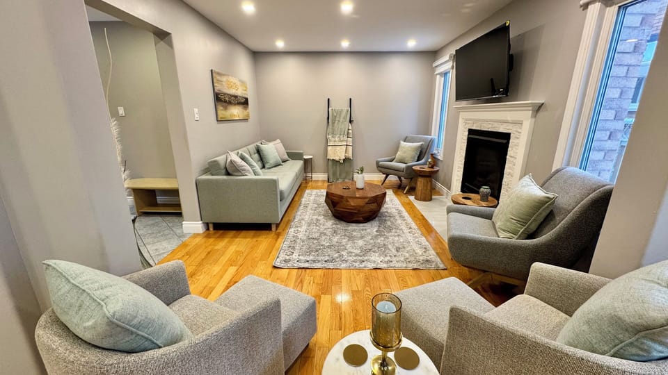 Living room with sofa bed, smart TV, and gas fireplace