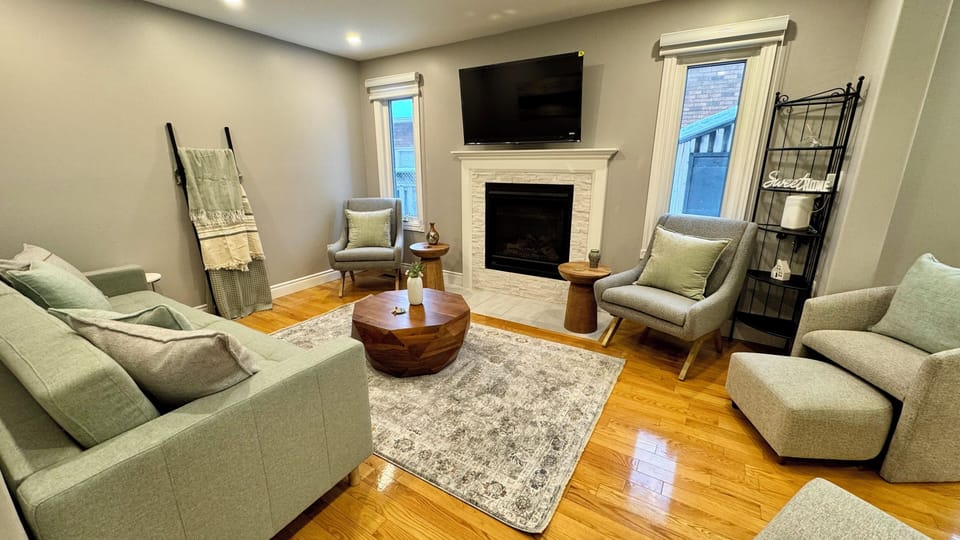 Living room with sofa bed, smart TV, and gas fireplace