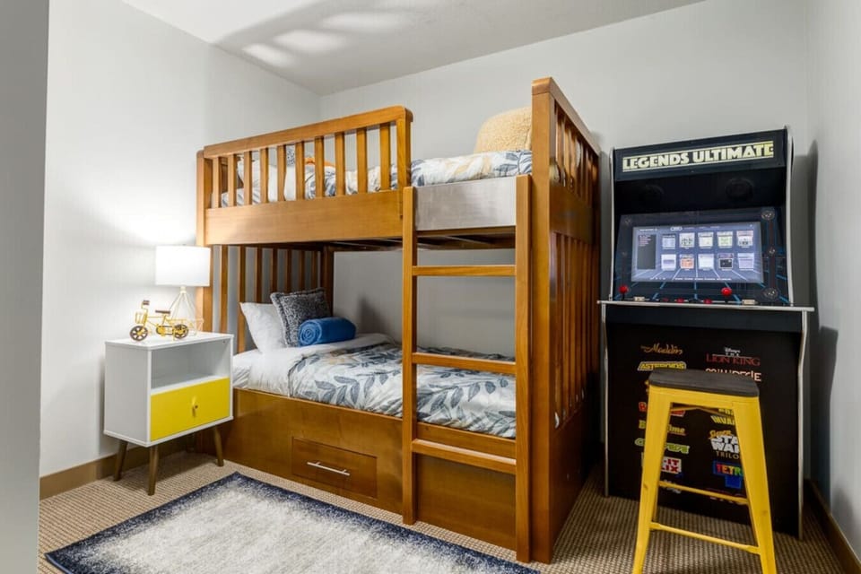 3rd bedroom with 2 single beds and arcade games.