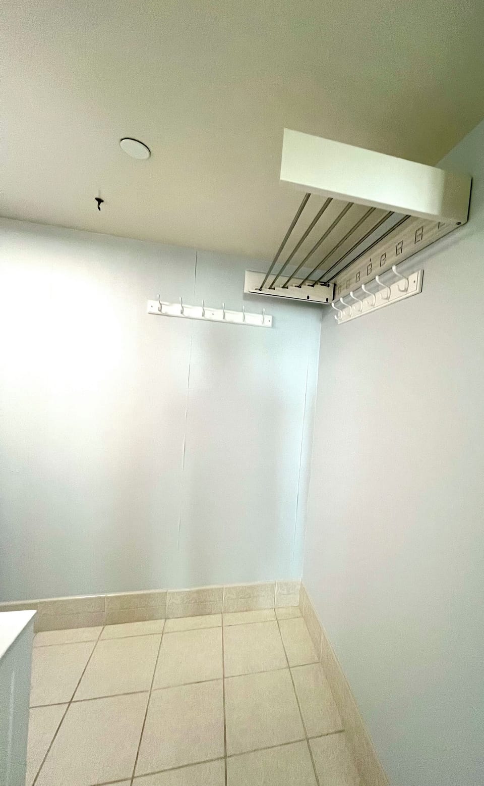 Laundry Room/Half bath with space to hang items including a pull out drying rack