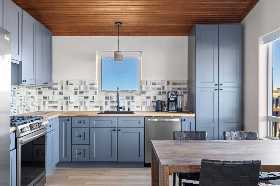 Bright open kitchen with a custom backsplash made of tiles reminiscent of Agnes Martin's geometric abstract art.