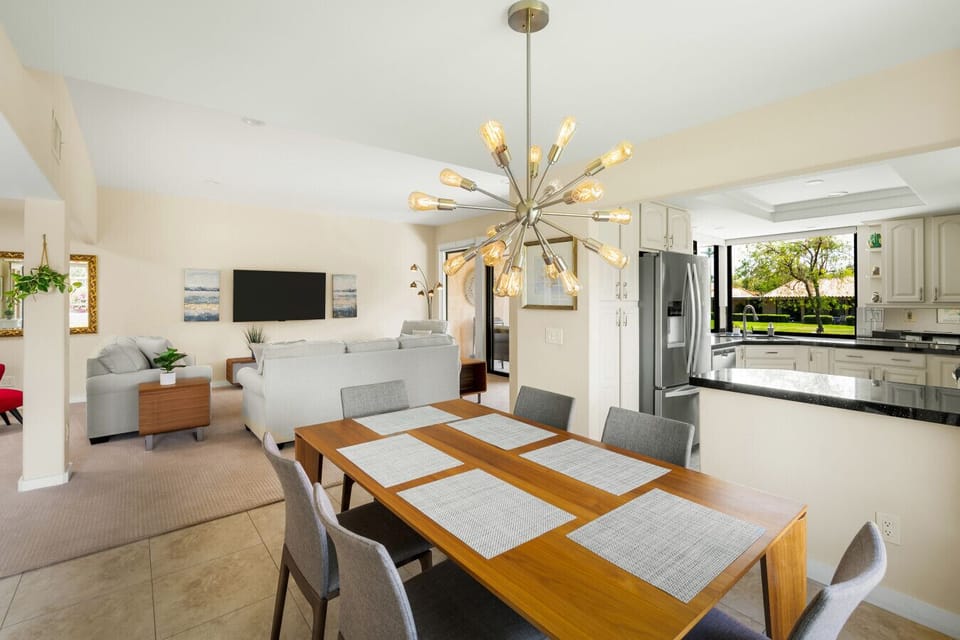Inviting dining area with sleek table and eye-catching overhead light.