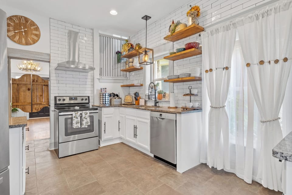 Open-concept kitchen with stylish finishes and plenty of natural light—your home base for quick meals or long stays in central Kansas City.