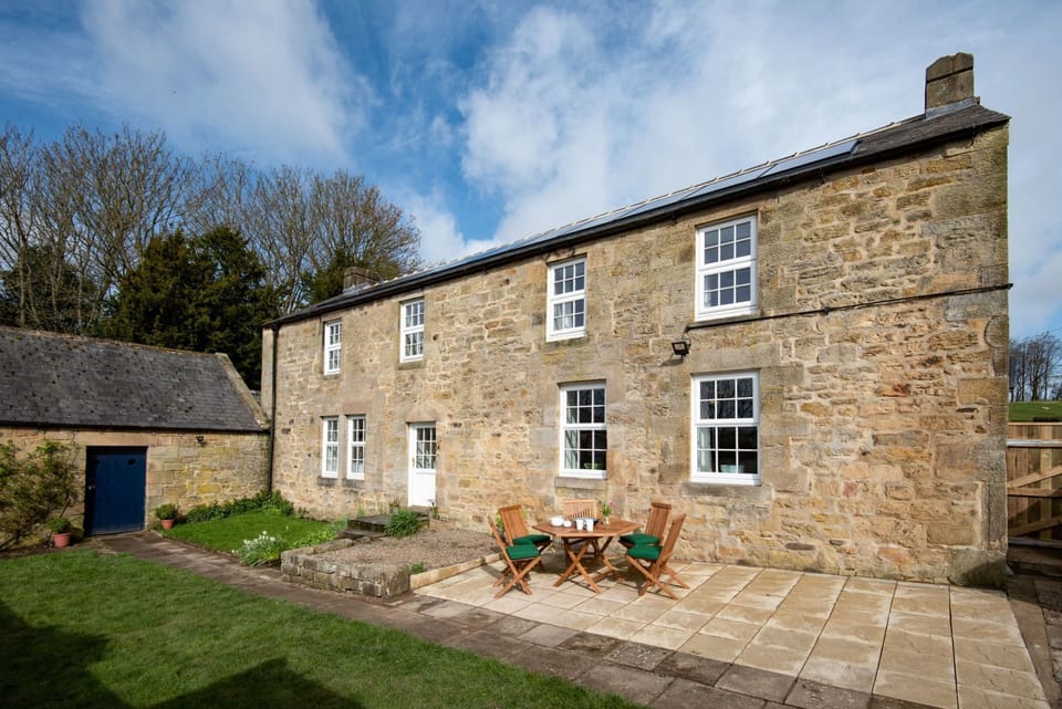 Grange House - front aspect of the property with lawned garden and patio
