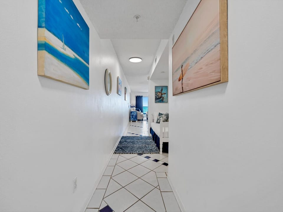 Step into your welcoming hallway adorned with beautiful ocean artwork that sets the coastal mood for your entire stay.