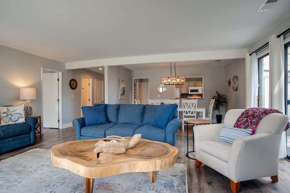 Sink into plush blue sofas and gather around the stunning wooden coffee table in your bright, open living space.