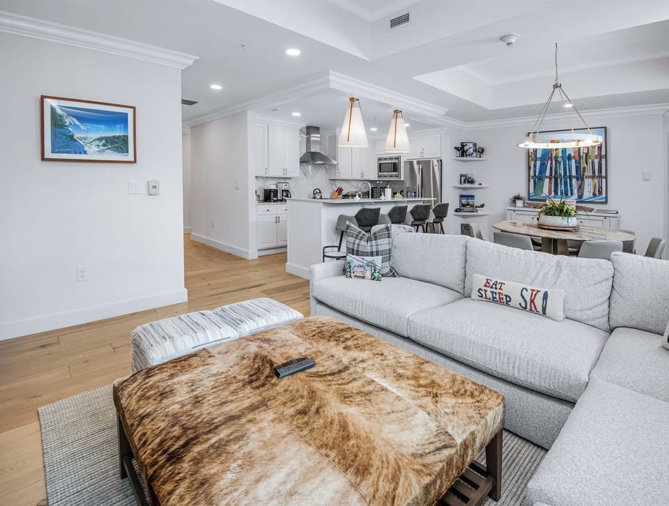 Relax on plush seating in your open-concept living space, where a cozy dining area and fully-equipped kitchen invite easy entertaining and mountain-town charm.
