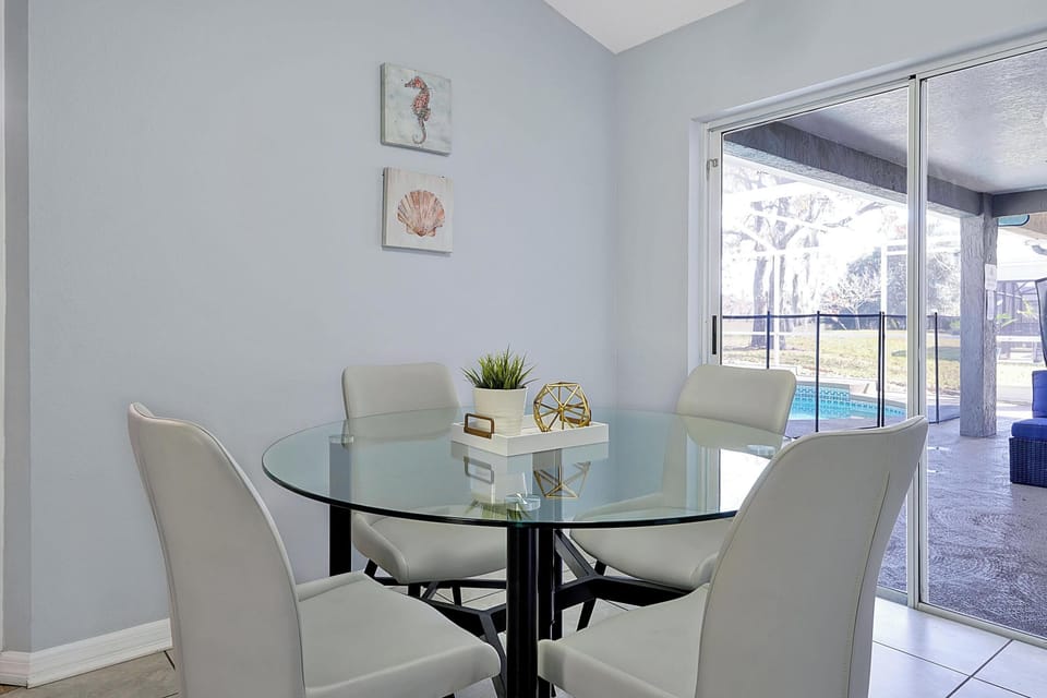 Enjoy your morning coffee, all set beside a bright sliding door with a poolside view.