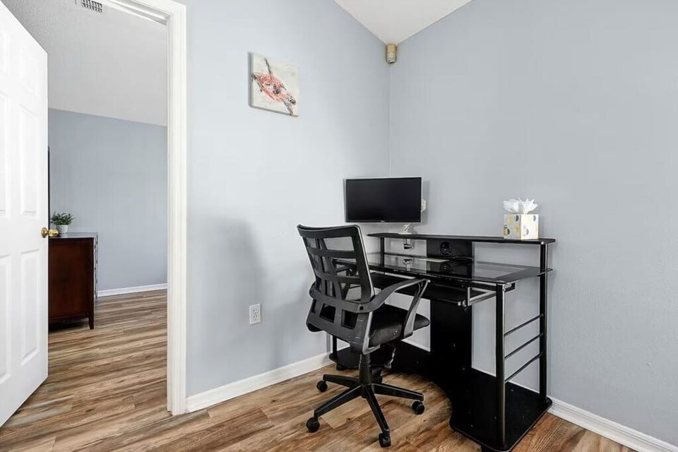 Quiet home workspace! This sleek desk and ergonomic chair provide a comfortable spot for remote working.