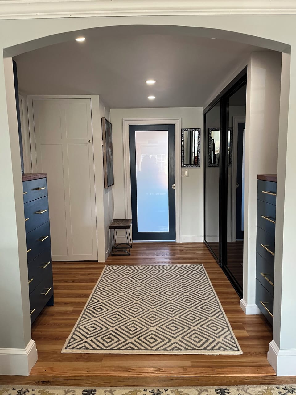 Primary bedroom closet area with washer and dryer closet