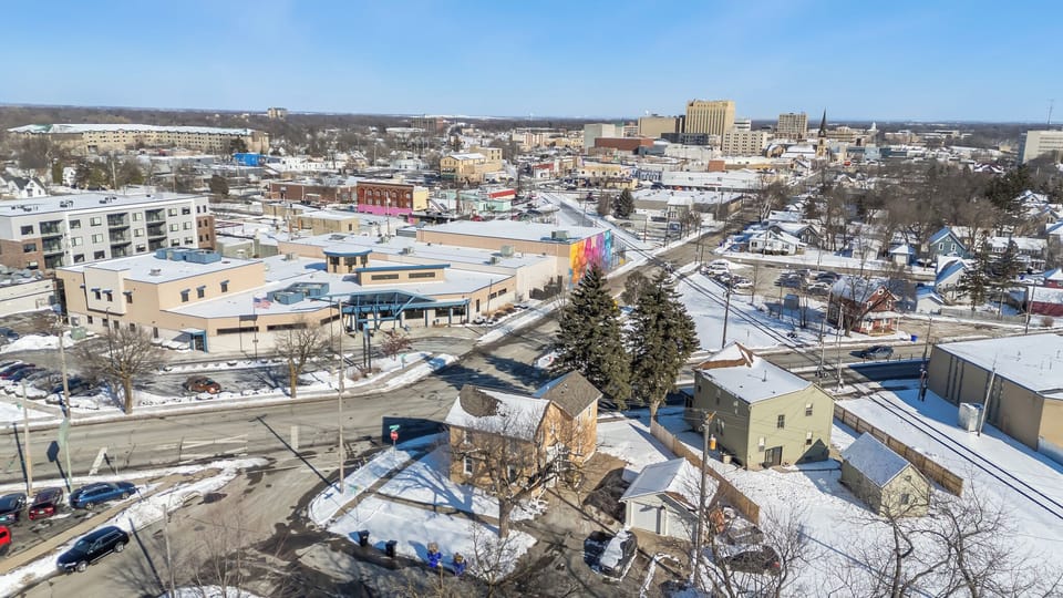 . Nestled in a peaceful neighborhood, it offers a panoramic view of the winter wonderland. Perfect for a quiet retreat with a large out lot to the right of the garage that's great for our furry friends or kids that may to burn off some energy.