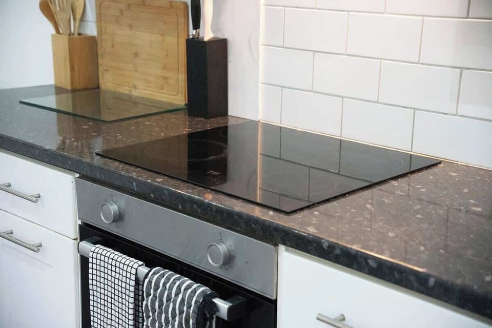 Kitchen equipped with all essentials, including a washer & dryer, oven, fridge and full cookware set.
