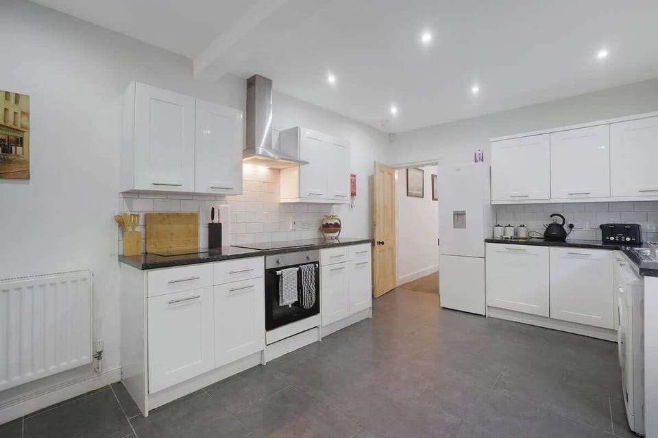 Kitchen equipped with all essentials, including a washer & dryer, oven, fridge and full cookware set.