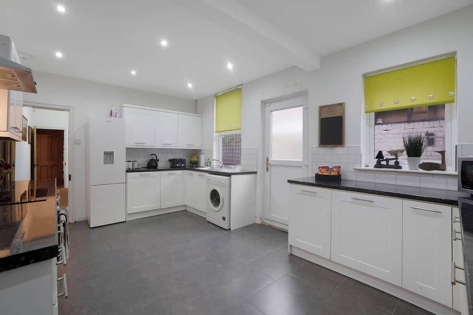 Kitchen equipped with all essentials, including a washer & dryer, oven, fridge and full cookware set.