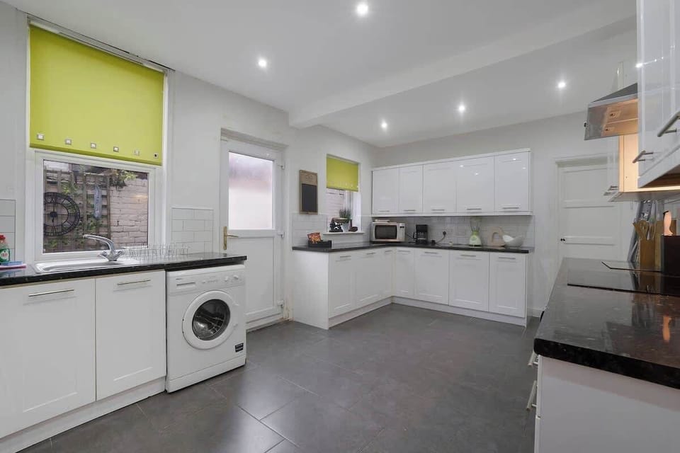 Kitchen equipped with all essentials, including a washer & dryer, oven, fridge and full cookware set.