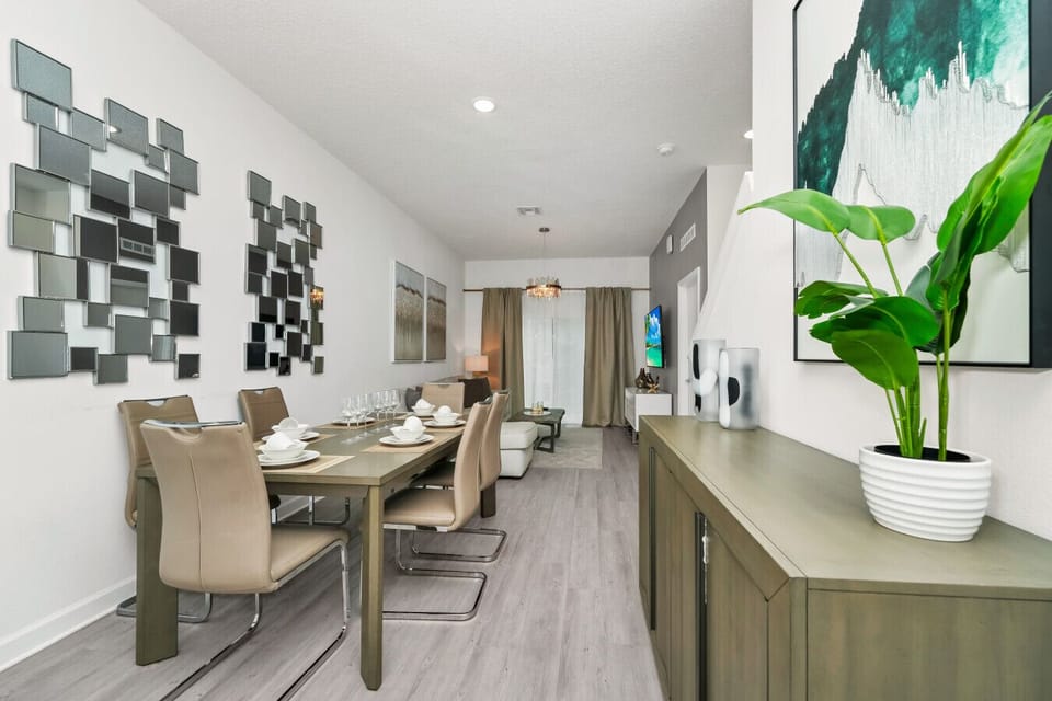 The dining area featured a rustic wooden table surrounded by comfortable chairs, perfect for enjoying meals with family and friends against a backdrop of softly glowing candles.