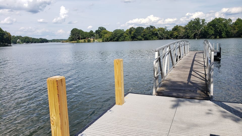 Small dock next to boat launch ramp