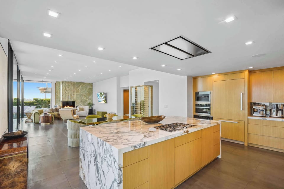 Marble island and custom cabinetry seamlessly blending into the sophisticated living area.