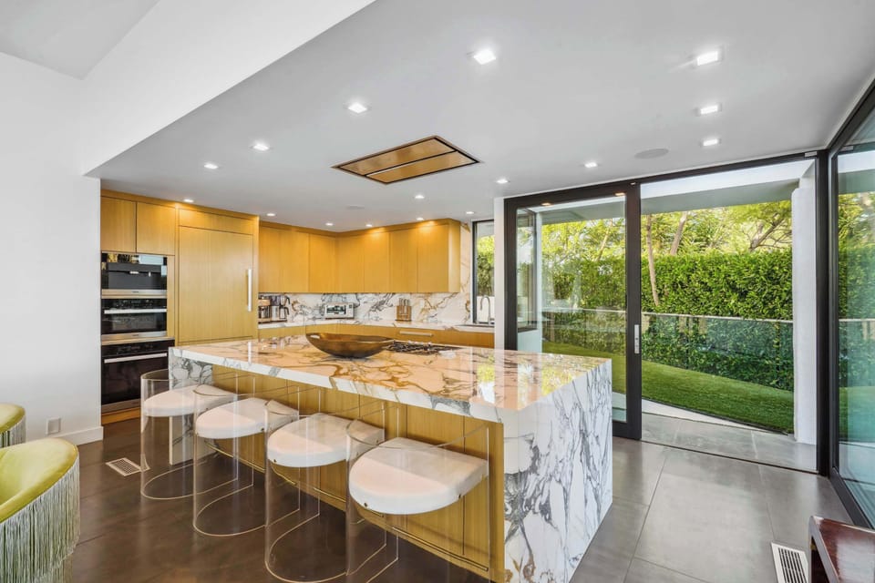 Gourmet kitchen with a stunning marble island, custom cabinetry, and sweeping outdoor views.